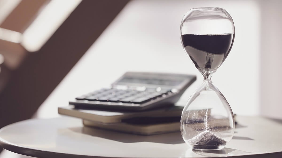 Hour glass and calculator on an end table