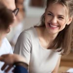 Woman looking at two co-workers and laughing.