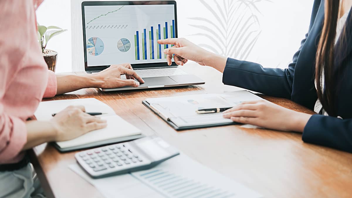Business owner and accountant reviewing financial charts.