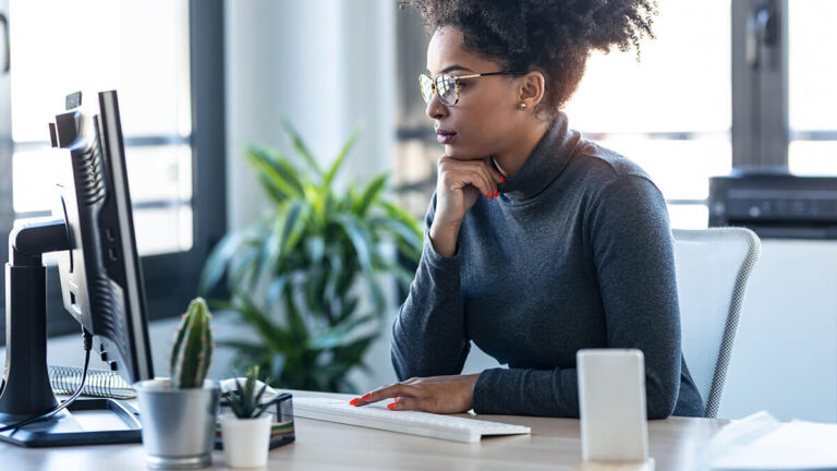 Focused woman looking at a computer.