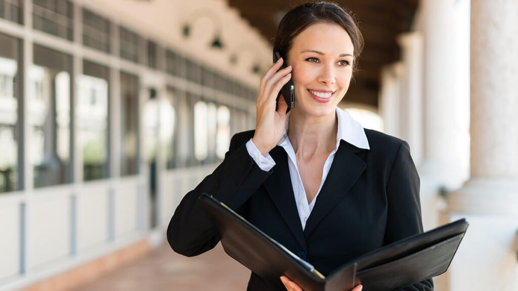 Woman on the phone learning how to qualify a small business for SBA loans.