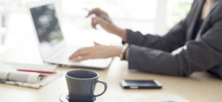 woman typing on keyboard to avoid payroll mistakes and have a stress free payroll process