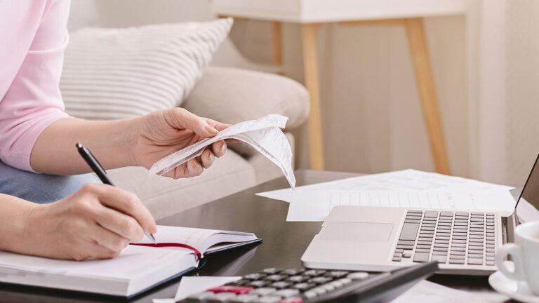 Woman holding receipts.