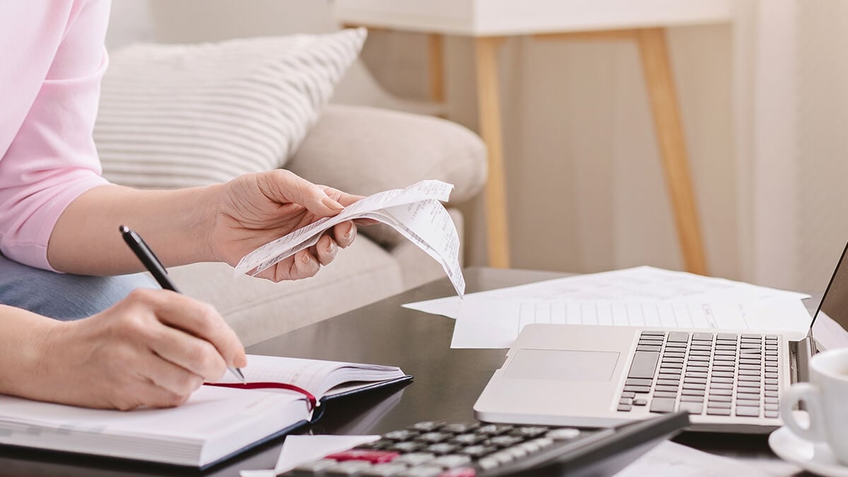 Woman holding receipts.