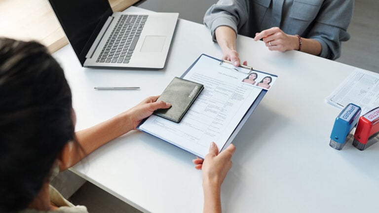 Woman receiving immigration paperwork.