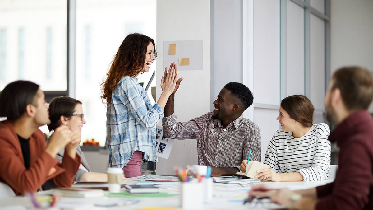 Small business interns in a meeting room.