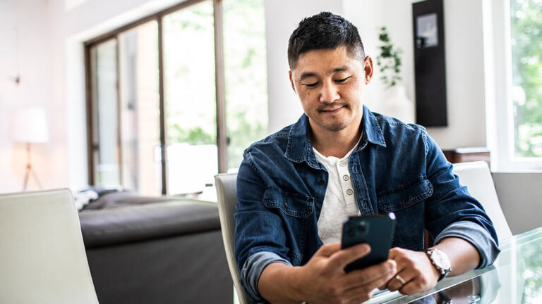 Man viewing IRS Form 1099 on a cell phone.