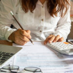 Woman filling out financial statements.