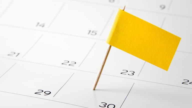 yellow flag marking specific date on a desk calendar