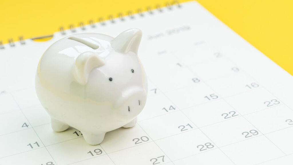 White piggy bank on a calendar.