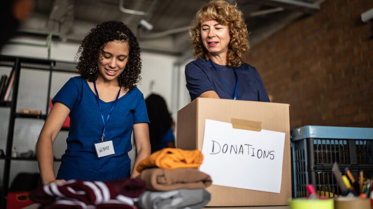 Two women accepting donations at a nonprofit.