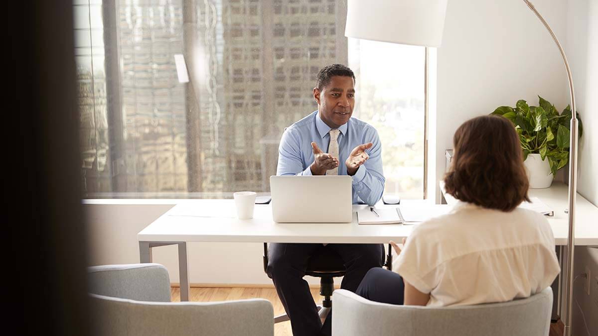 Man explaining escheatment law to a client.