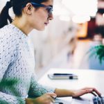 Employer reviewing tax exemption on a laptop.