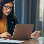 Business owner reviewing liabilities online.