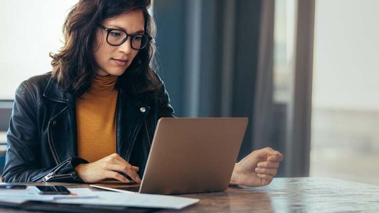 Business owner reviewing liabilities online.