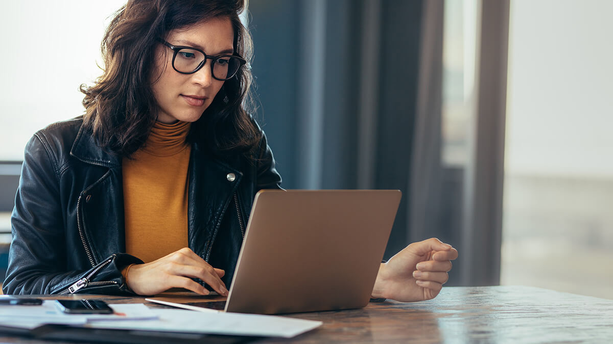 Business owner reviewing liabilities online.
