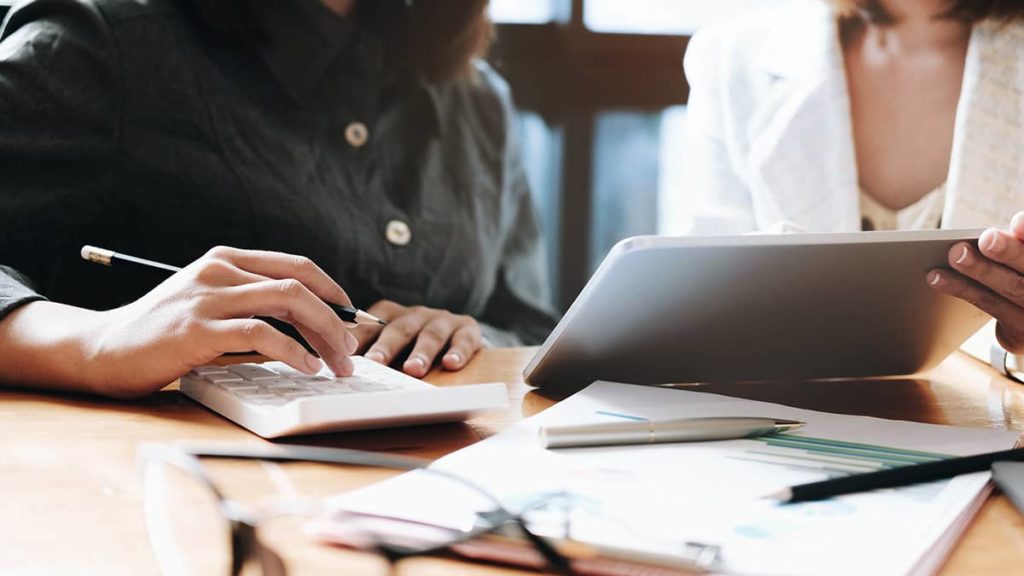 Two employees review the chart of accounts.