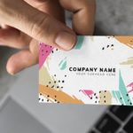 hand holding colorful business card out