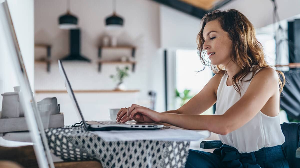 Woman filling out Form W-4 on laptop.