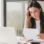 Stressed woman looking at business loss information.