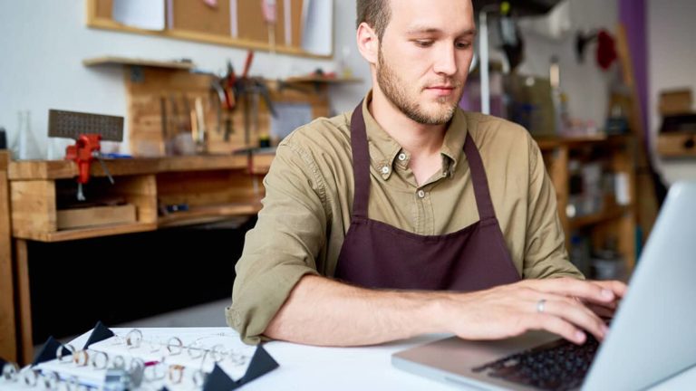 Man calculating EBITDA on his laptop.
