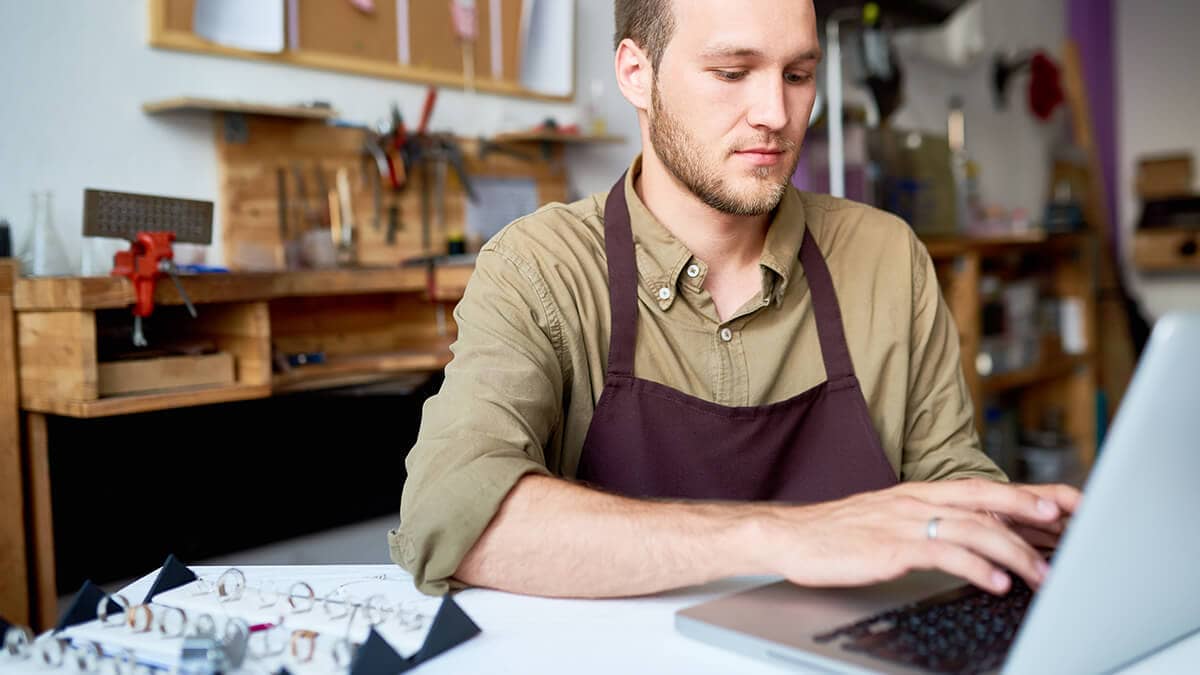 Man calculating EBITDA on his laptop.
