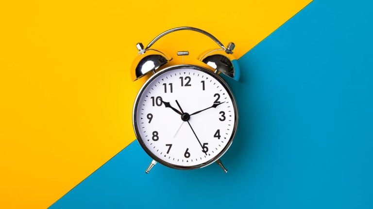 clock ticking with a bright yellow and blue background