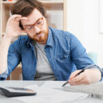 Stressed business owner writing off bad debt.