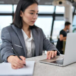 Focused woman looking at laptop.