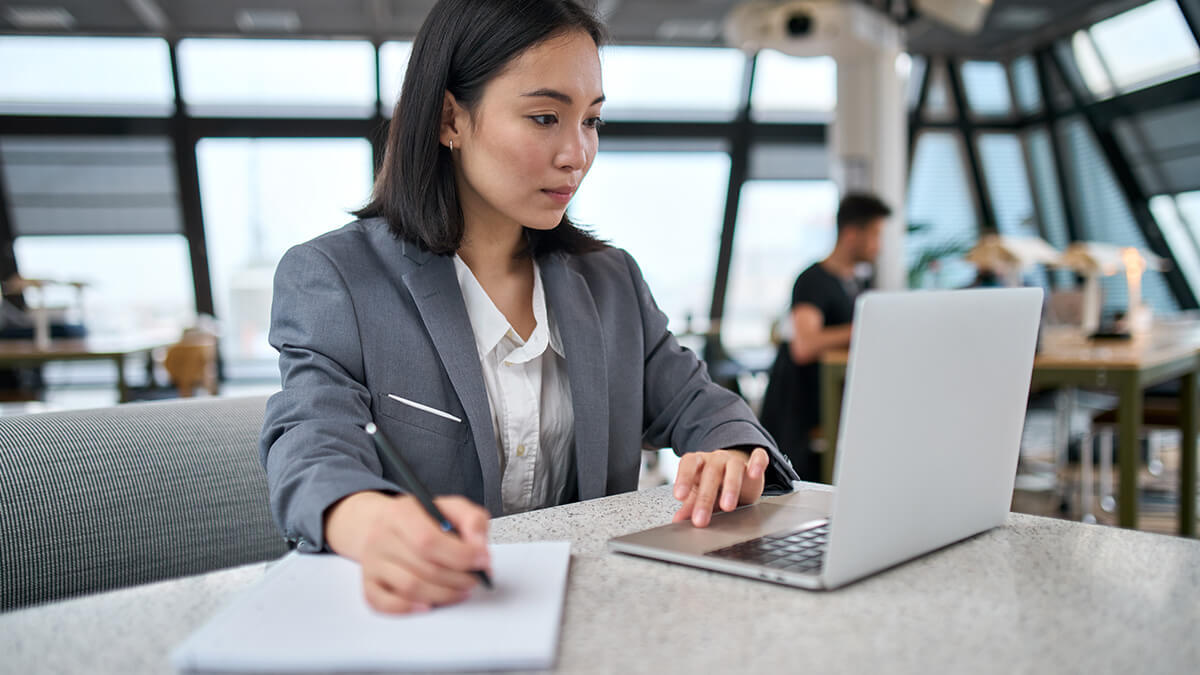 Focused woman looking at laptop.