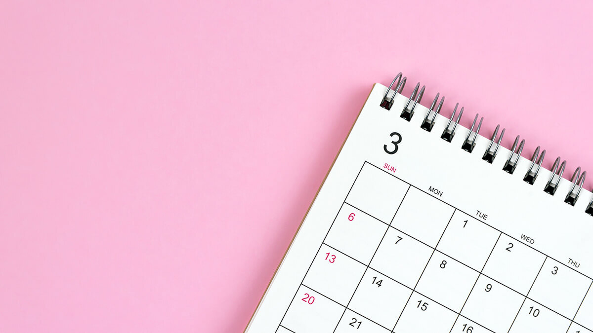 Calendar on a light pink background.