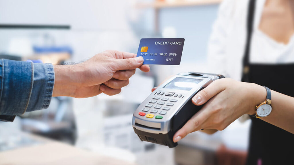 Business owner accepting a credit card from a customer.