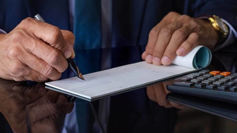 Employer writing a paycheck.