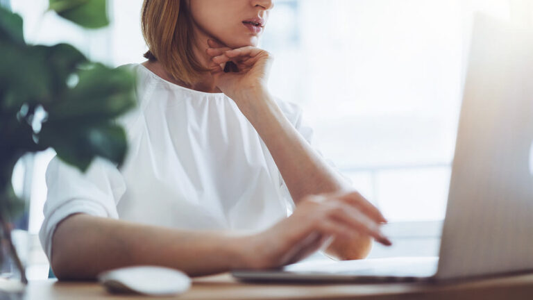 Self-employed woman looking at laptop.