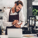 Barista taking an order over the phone.