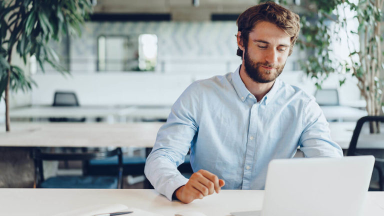 Man reviewing the cost of payroll services online.