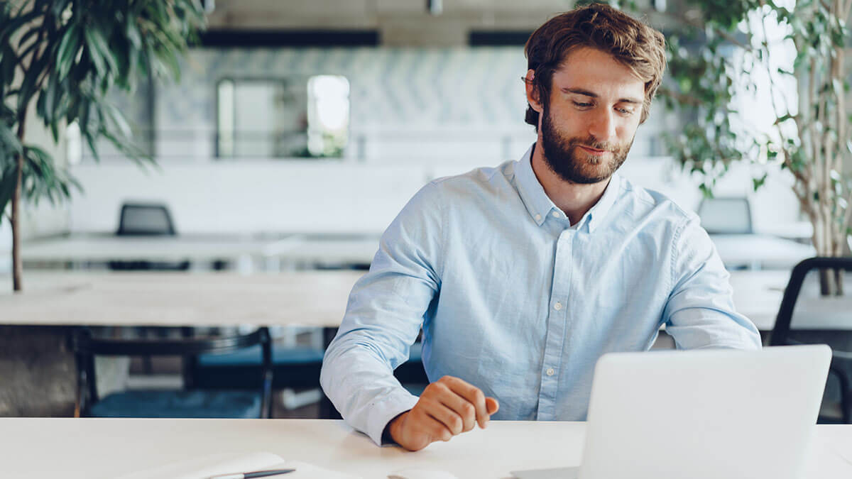 Man reviewing the cost of payroll services online.