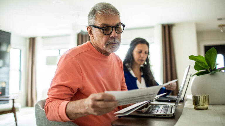 Husband and wife filling out filing status information.