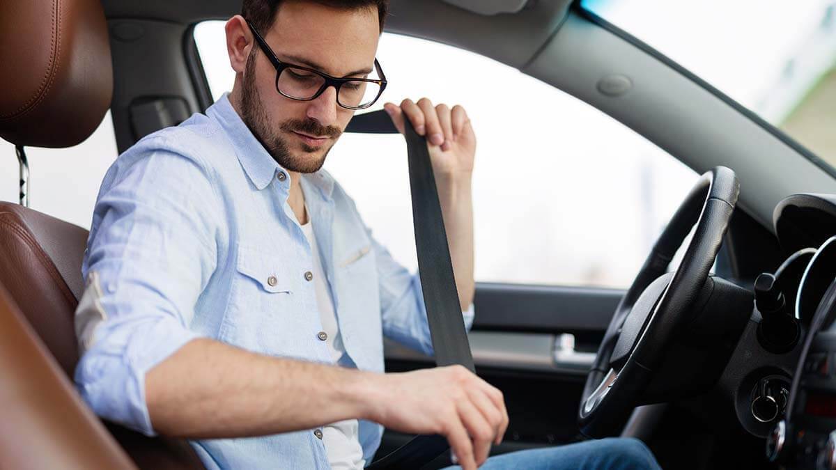 Employee buckling his seat belt.