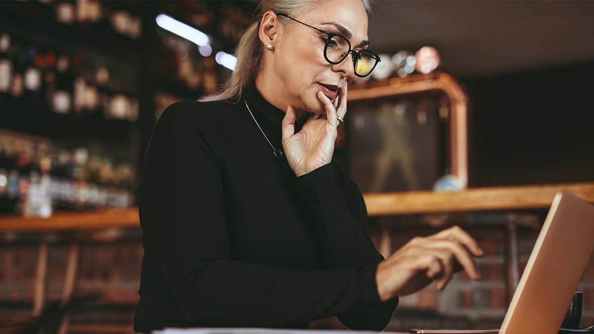 Middle aged woman using a laptop.