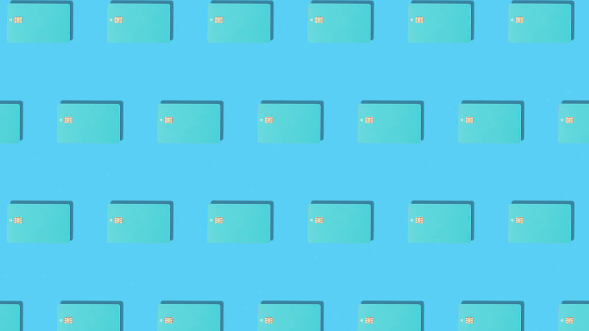 Rows of teal credit cards on a blue background.