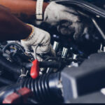 Mechanic working under the hood of a car.