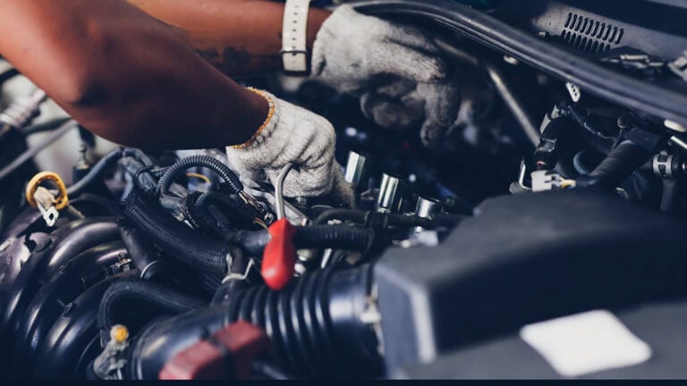 Mechanic working under the hood of a car.