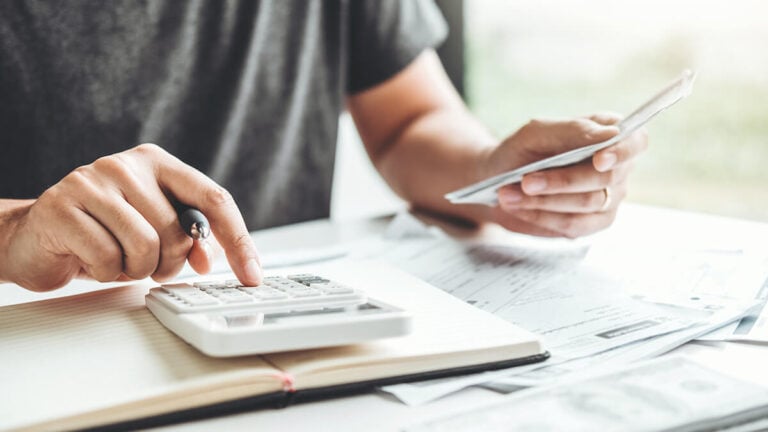 Man using a calculator.