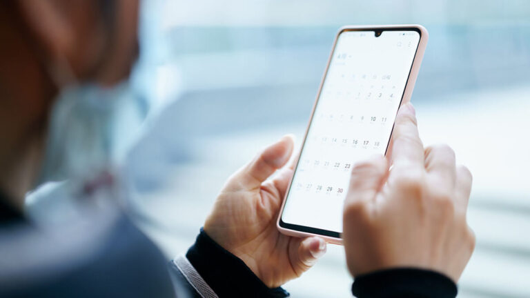 Cell phone with a calendar on it, showing pay frequency.
