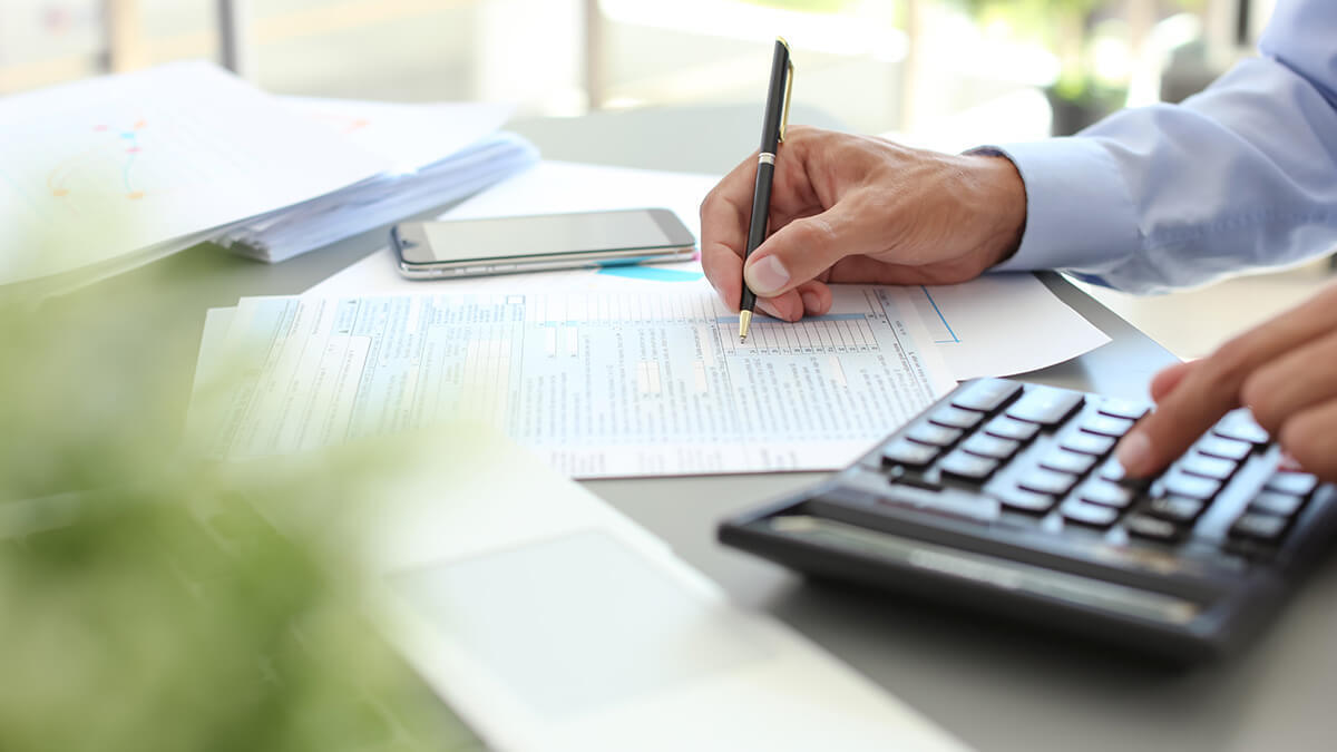Business owner filling out federal tax forms.
