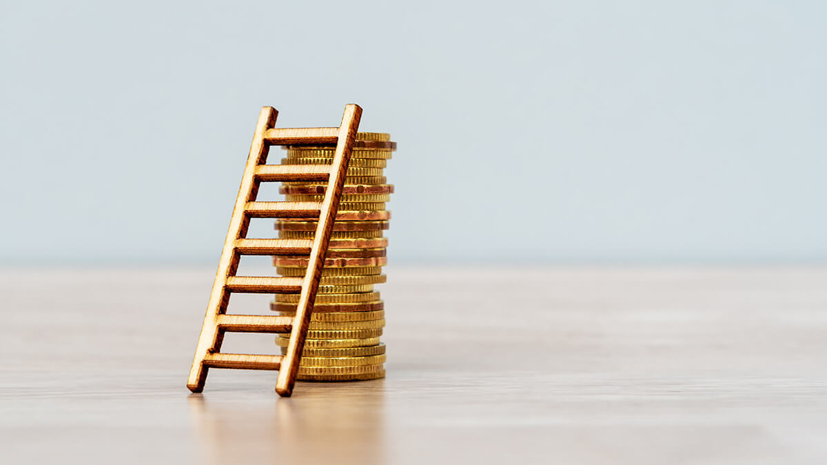 Stacked coins and a mini ladder.