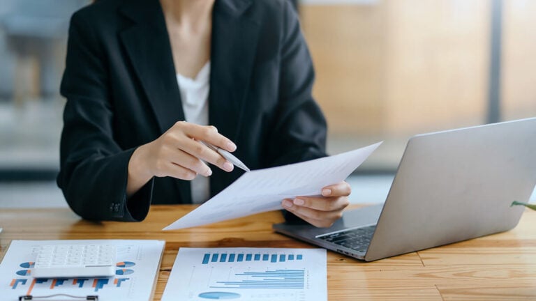 A woman holding a statement of retained earnings.