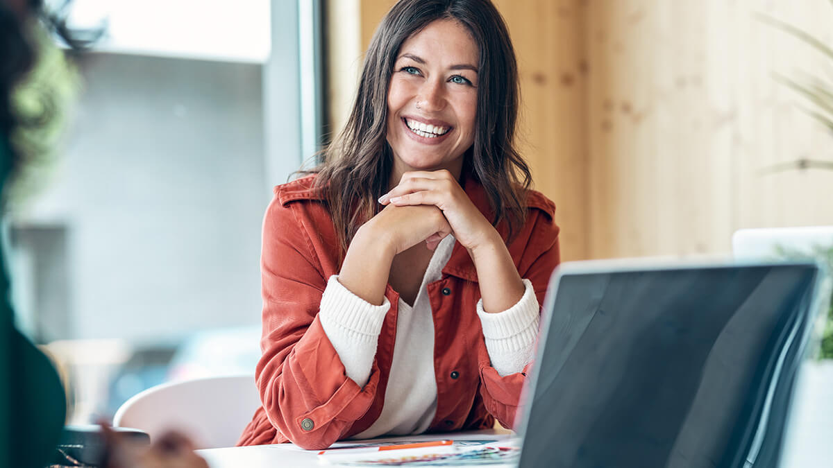 Smiling woman talking with someone off camera.