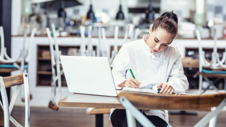Woman calculating her company's gross income.